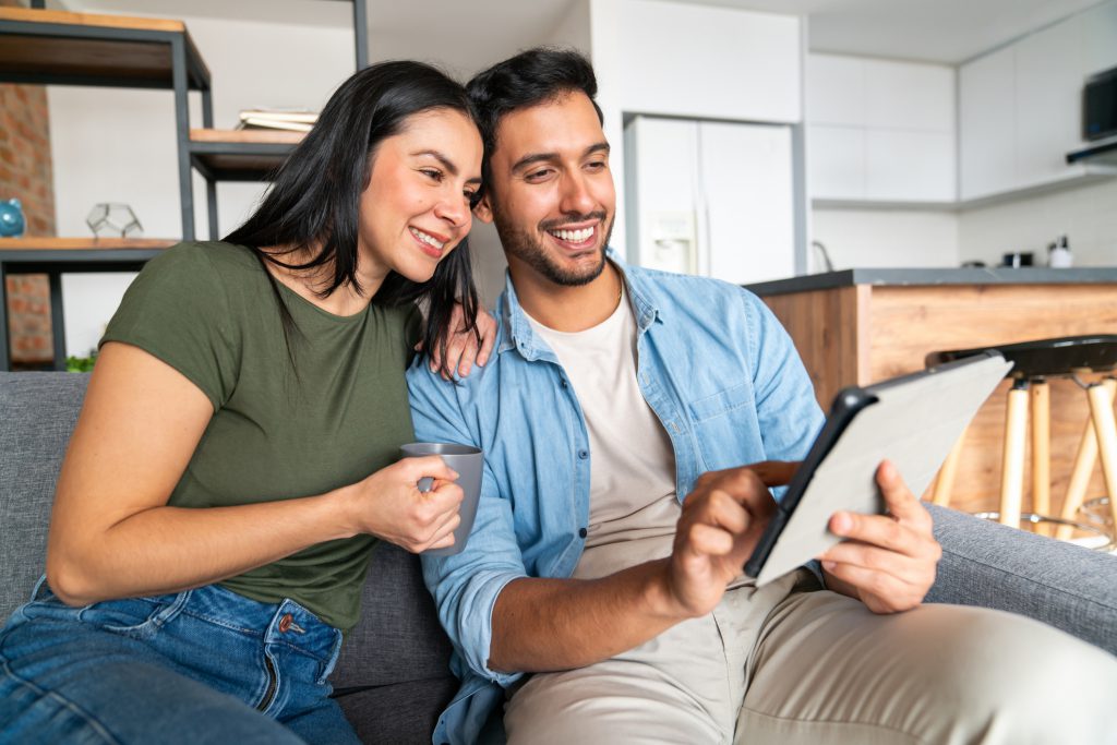 couple on couch using a digital tablet